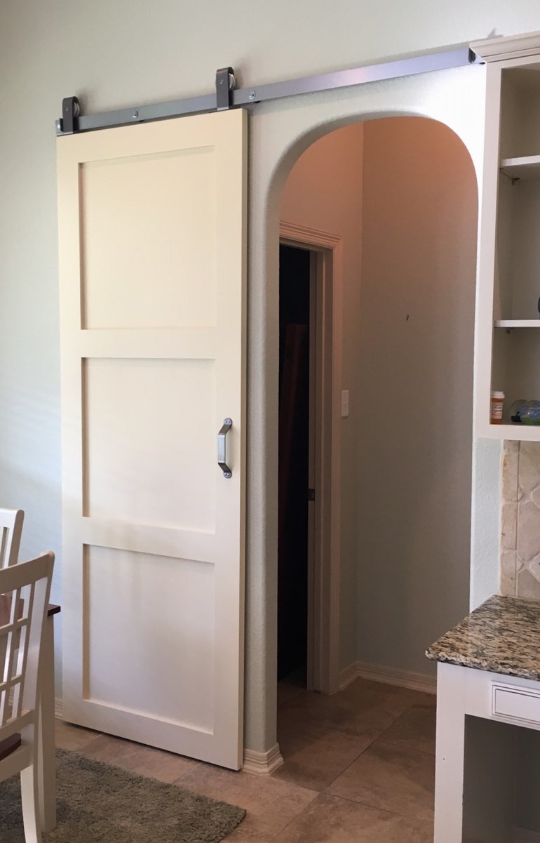 Contemporary style barn door in Houston kitchen.